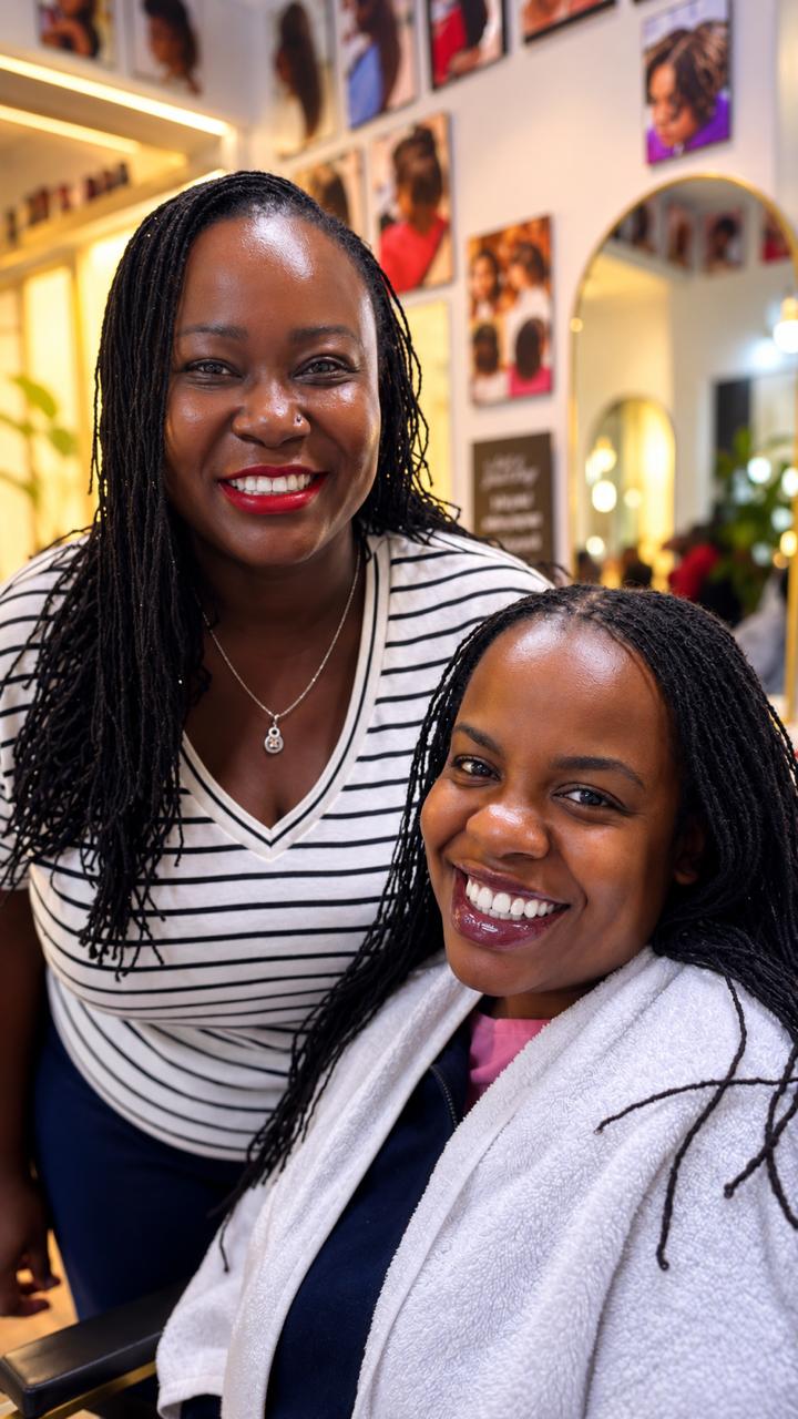 Client and stylist smiling after a Sisterlocks retightening appointment